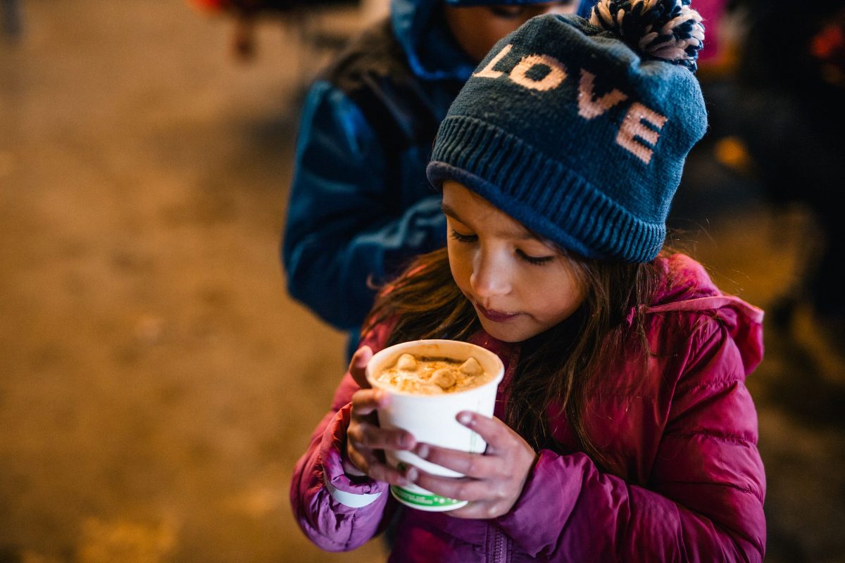 A girl sipping hot cocoa at Top of the Notch