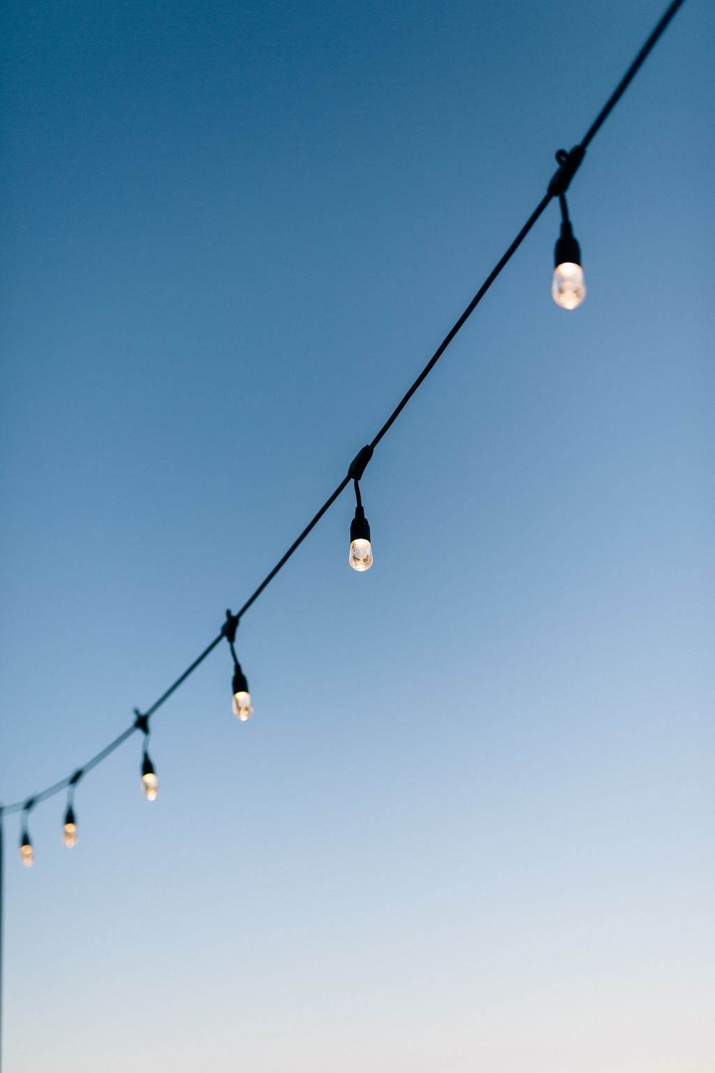 String lights glowing at dusk on the mountain