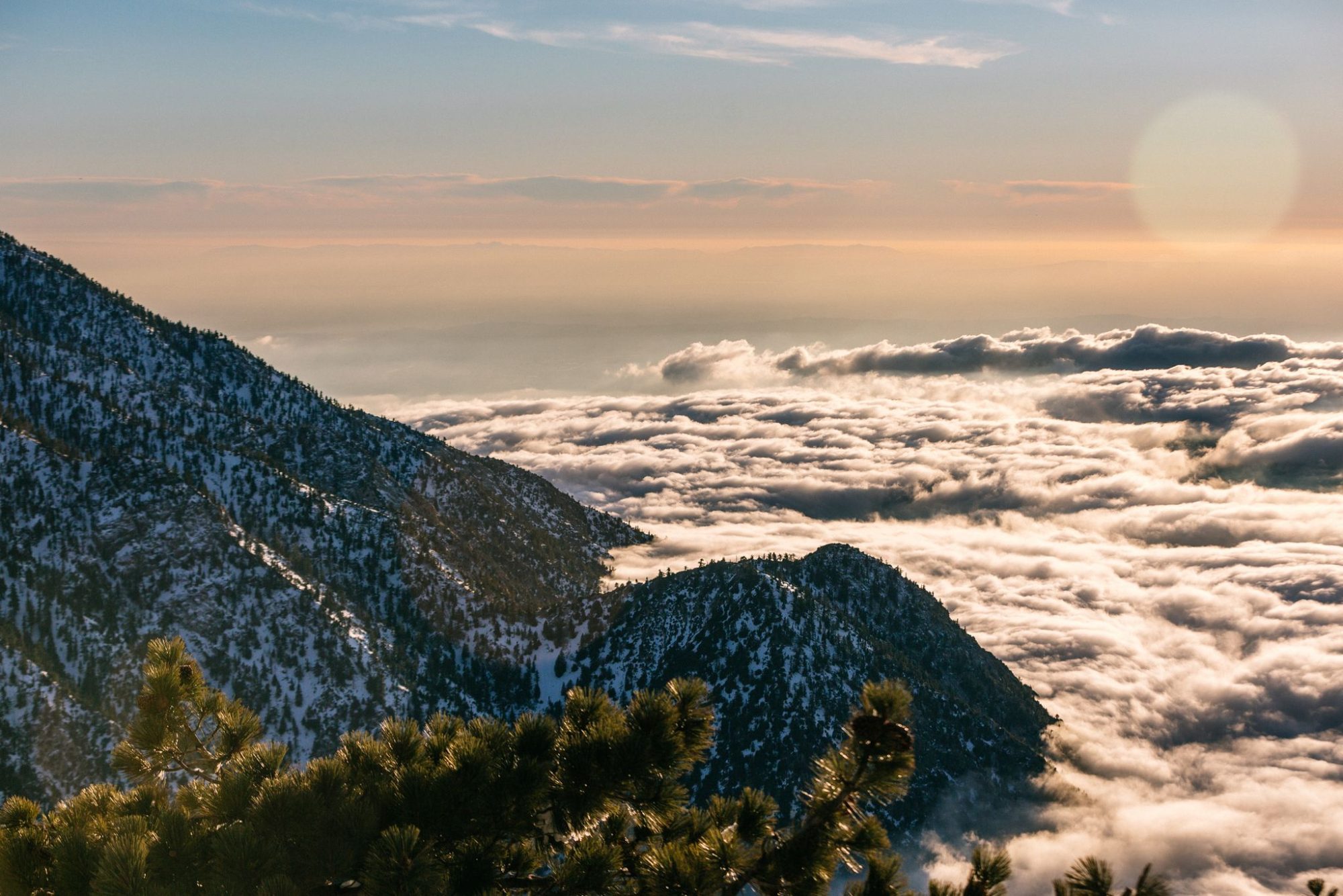 A sea of clouds below the ridge at sunset