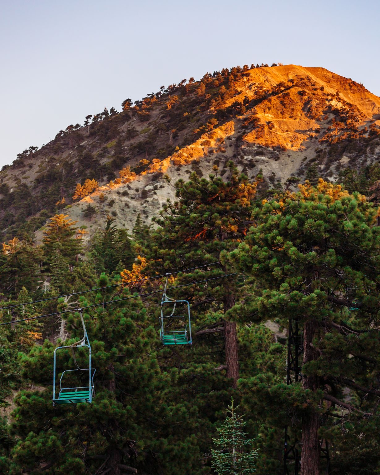 The chairlift below a peak glowing at alpenglow