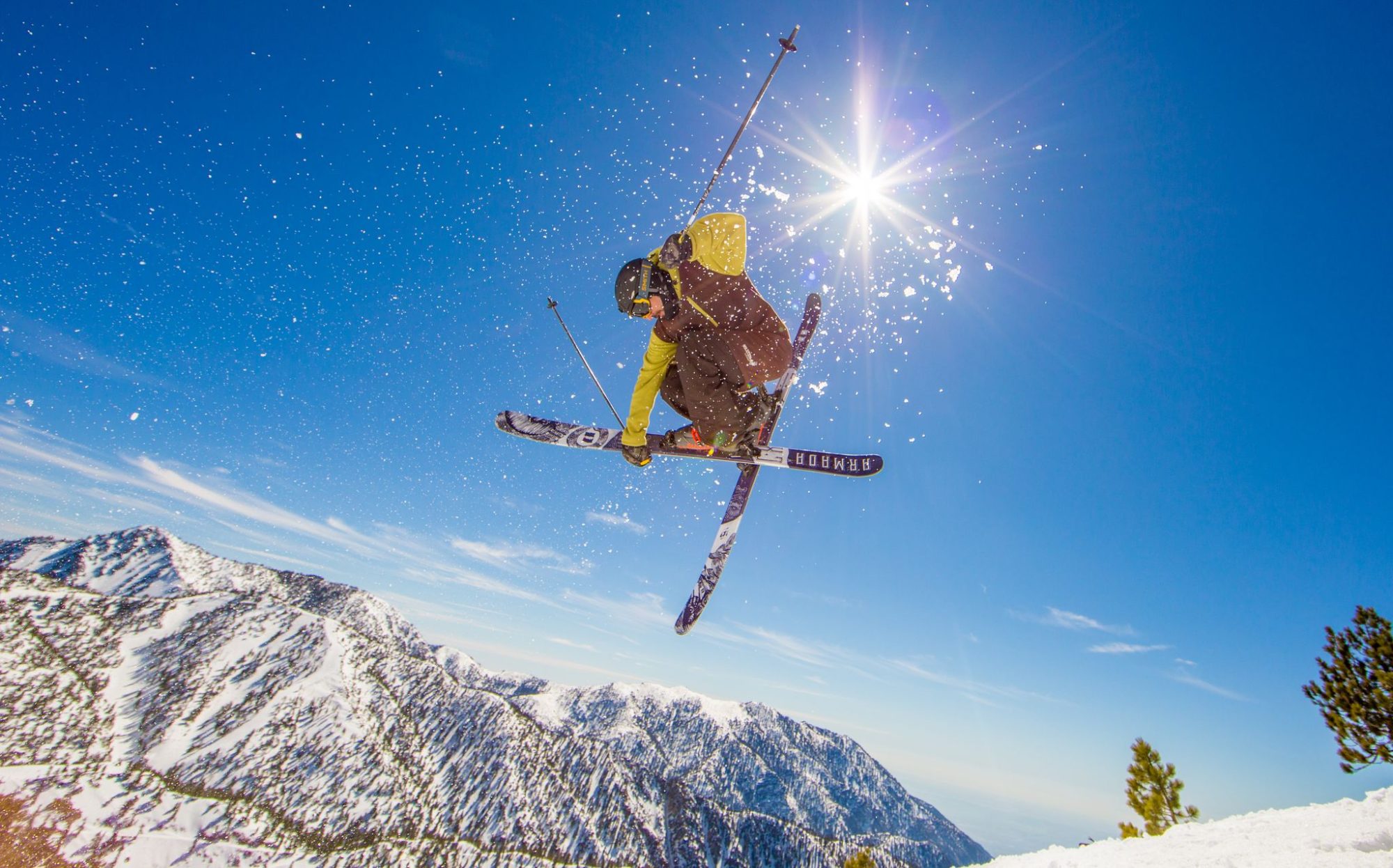 A skier jumping against a blue sky