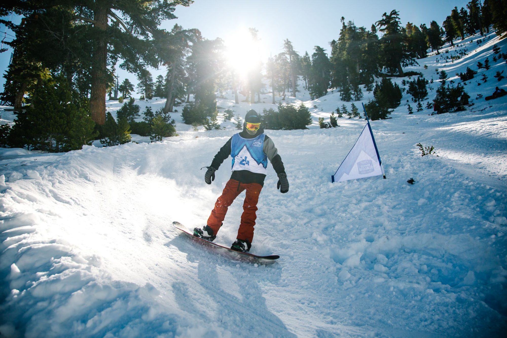 A rider spraying snow through a banked turn