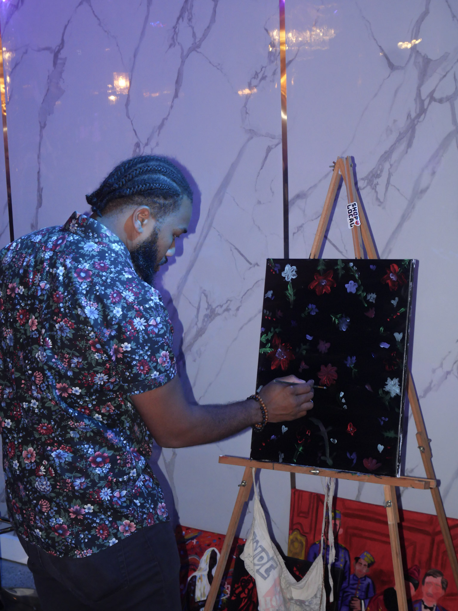 Live painter working on a canvas at a creative event at The Amador Gallery