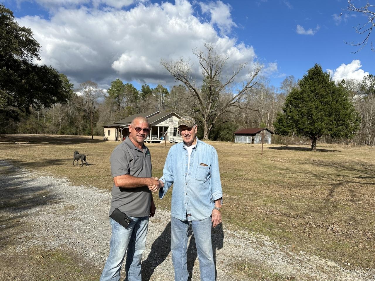 shacking hands with a happy customer after roof rejvuenation service