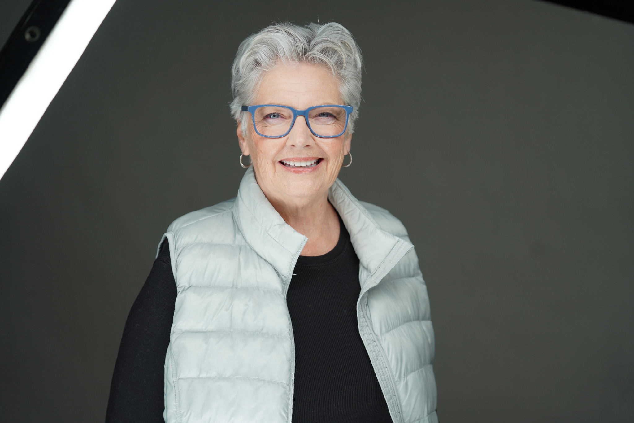 Tonja Demoff wearing blue glasses and a light vest