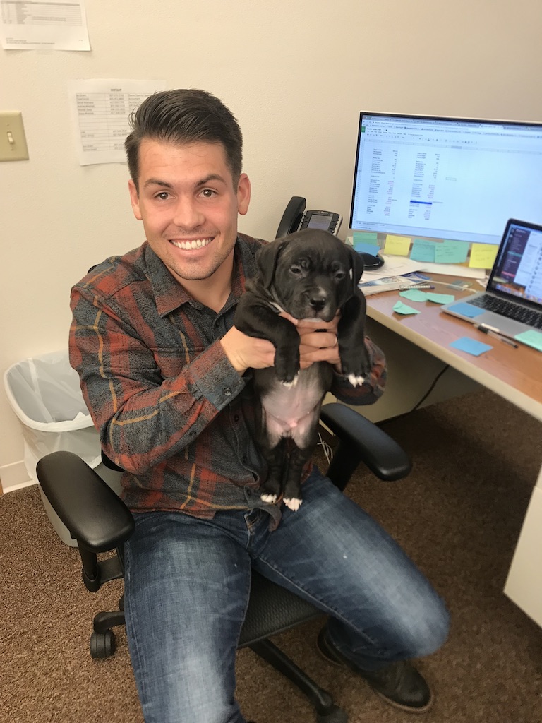Bo Grant in his office holding a puppy
