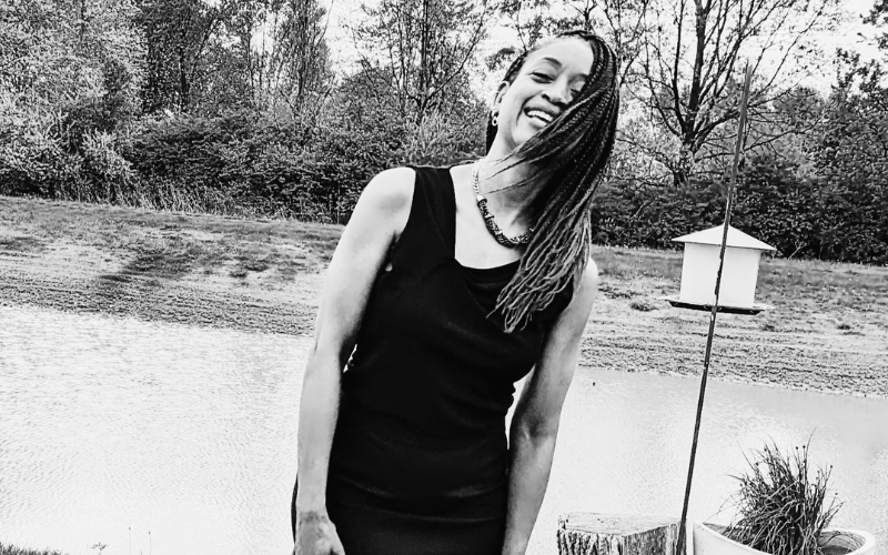 Leslie Sims Palmore smiling outdoors in a black-and-white photo, reflecting joy and personal growth.