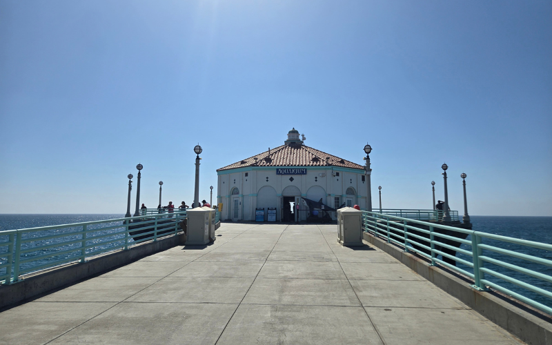 Ocean pier walkway leading toward a building, symbolizing courage and forward movement.