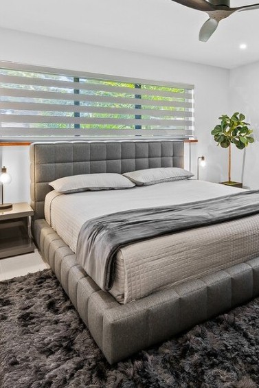 woman setting sheets on bed