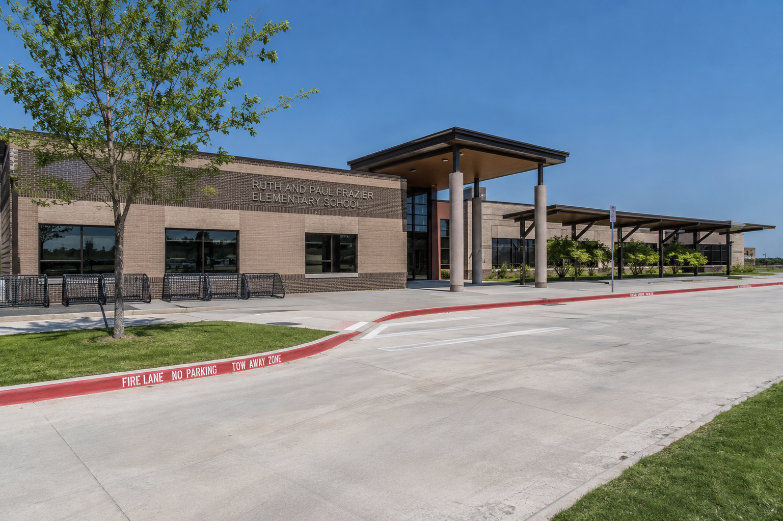 front exterior of Ruth and Paul Frazier Elementary School in McKinney, Texas, showing the main entrance and modern McKinney ISD school campus.