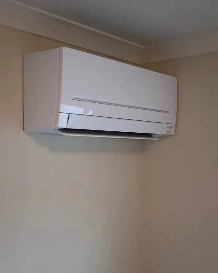 Mitsubishi Electric split system head unit installed high on an interior wall