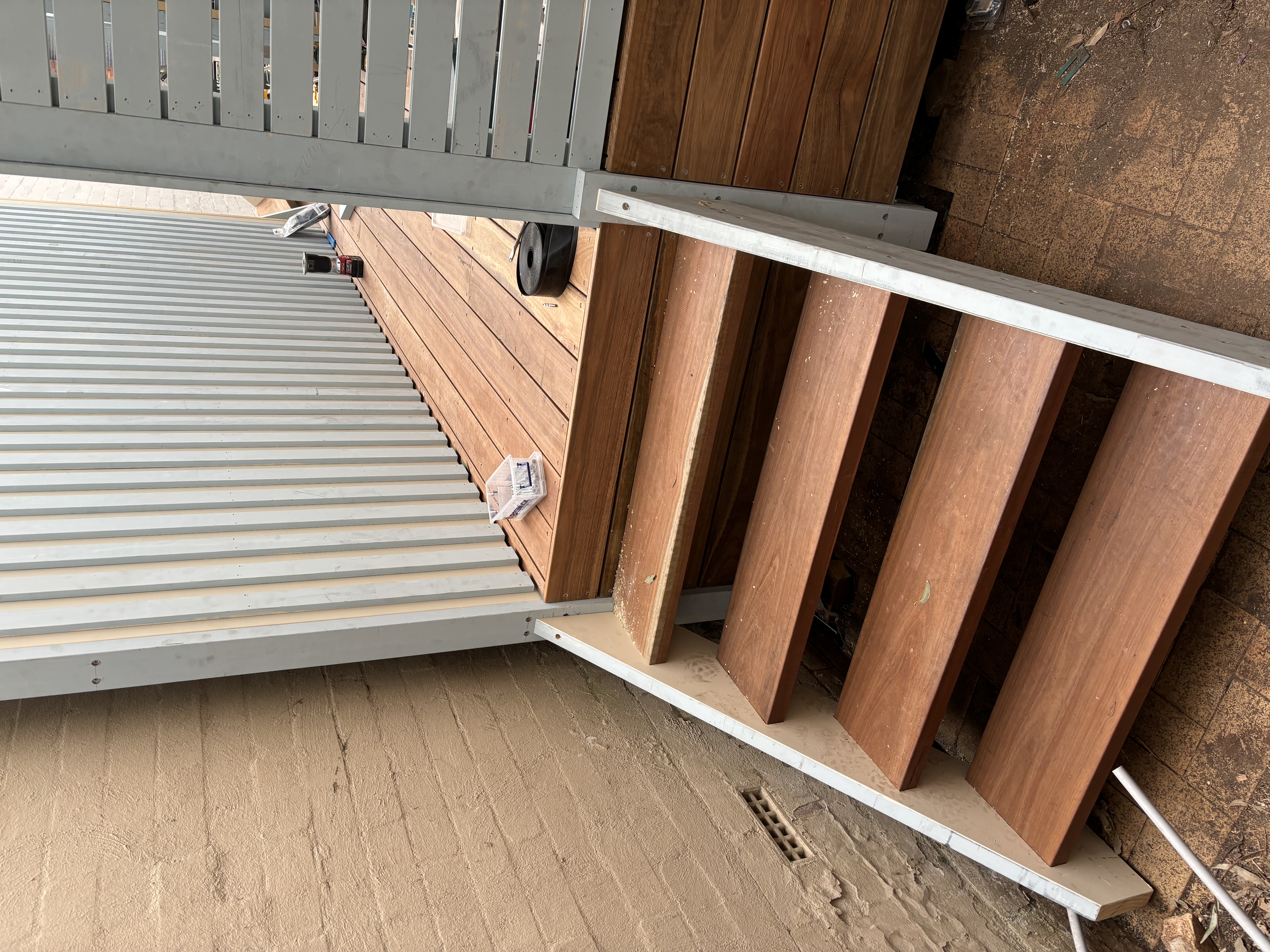 Hardwood stair treads on a painted stringer leading to a landing