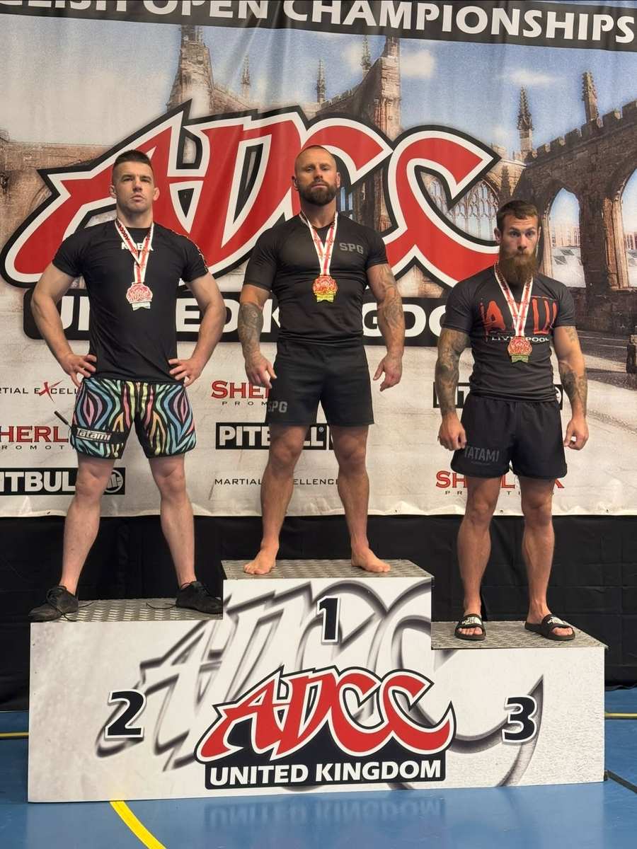Coach Sebastian Szyszka on top of the ADCC UK podium