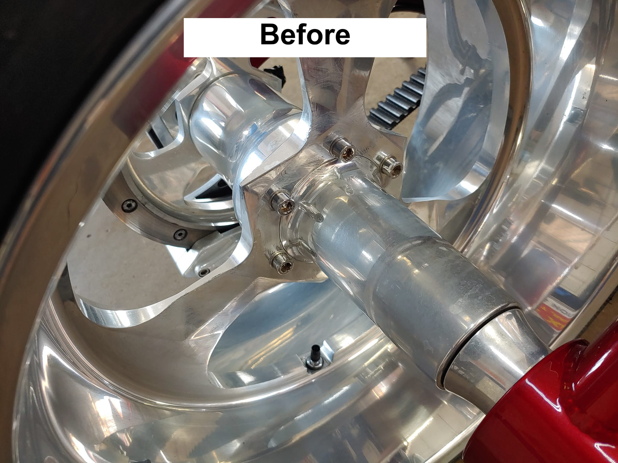 Chrome motorcycle wheel before detailing — oxidized and tarnished