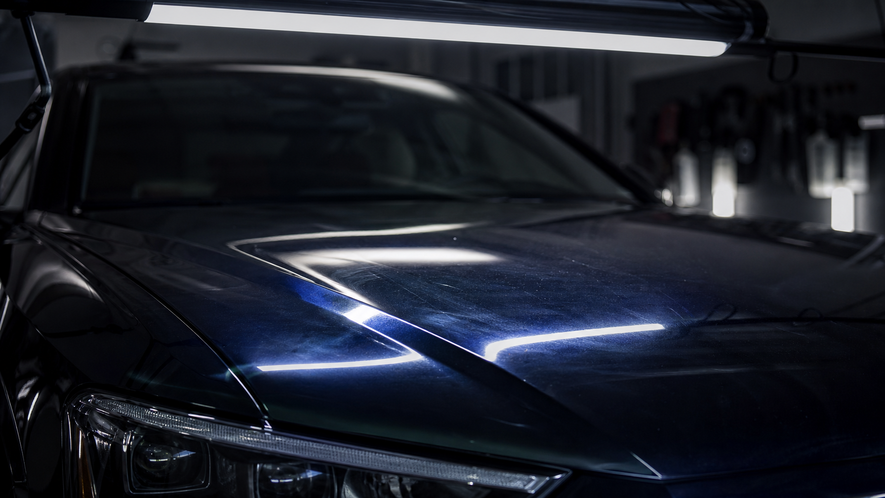 Paint correction service in Fort Worth DFW — swirl marks visible on dark paint under LED inspection light