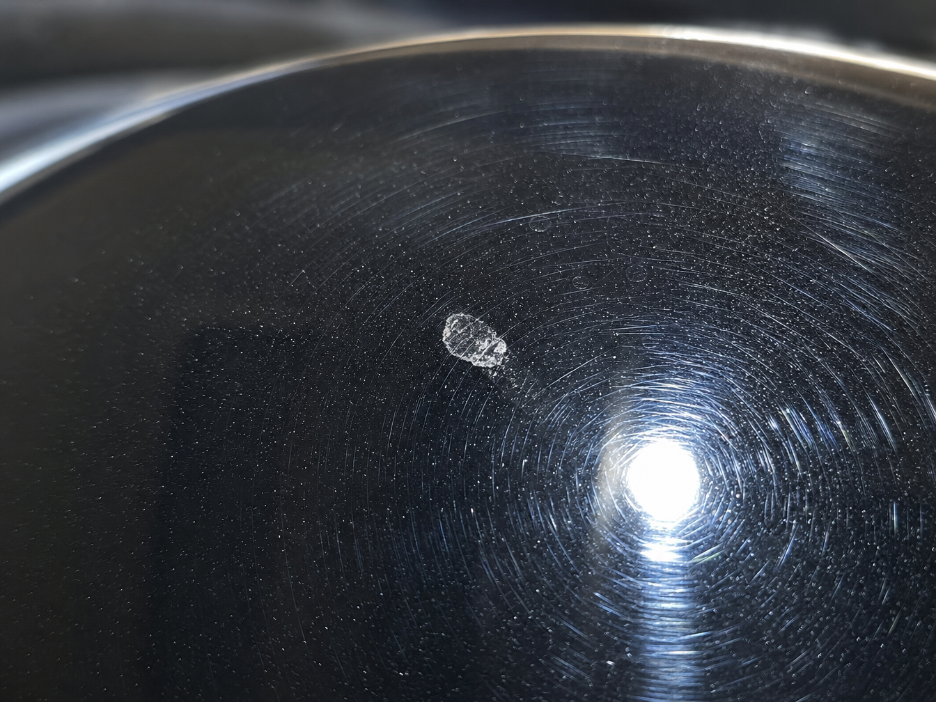 Swirl marks and water spot etching on black car clear coat before paint correction