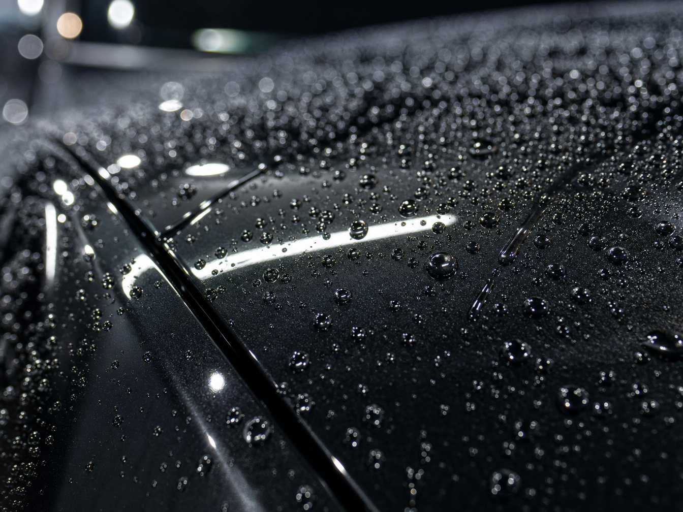 Water beading on ceramic coated car paint after paint correction — hydrophobic effect