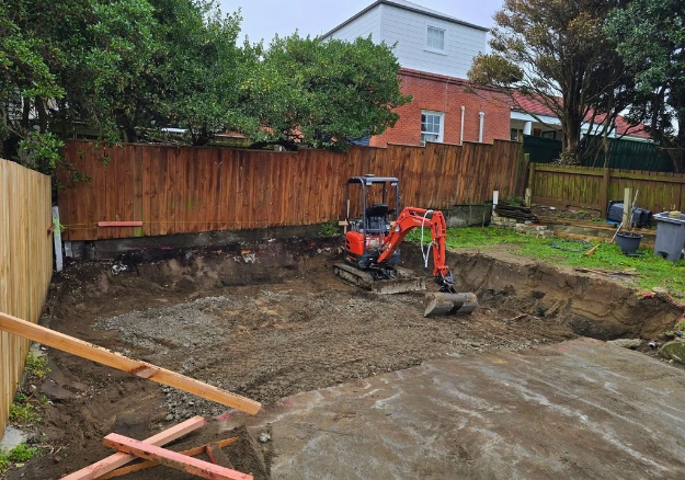 Professional excavator operator clearing site in Porirua