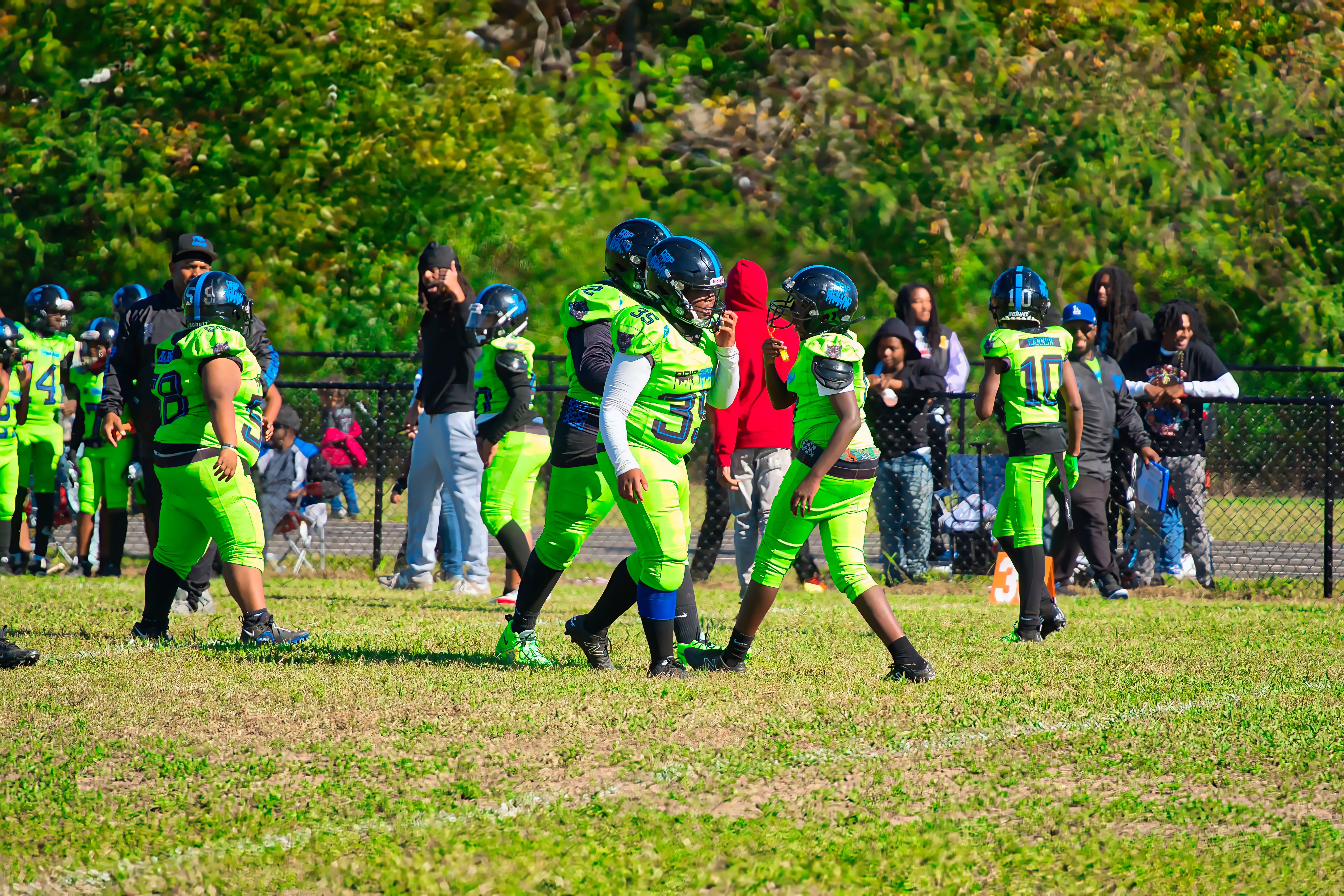 Youth football player making a cut during live game action