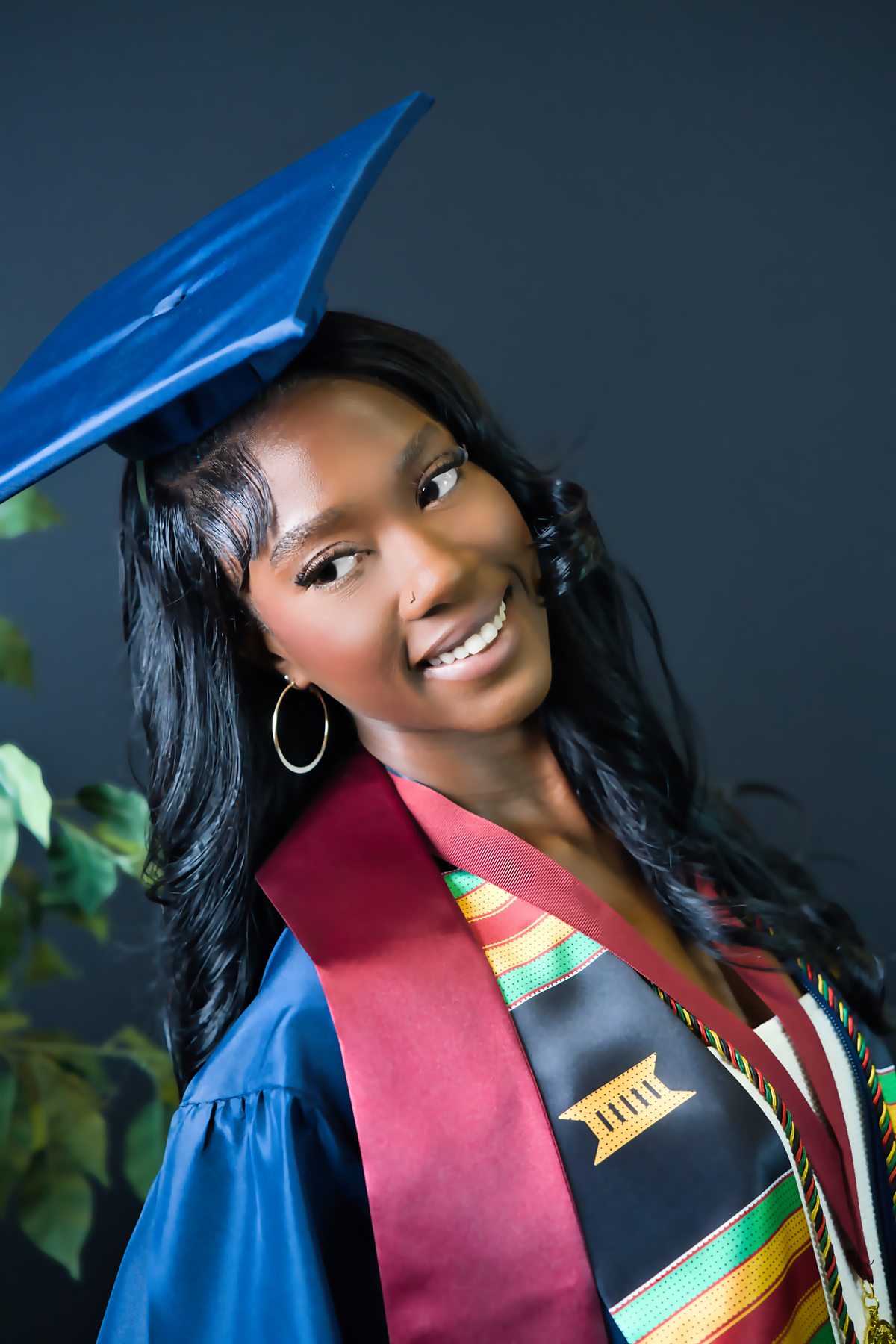 Graduate in cap and gown photographed by Dreamin Innovations