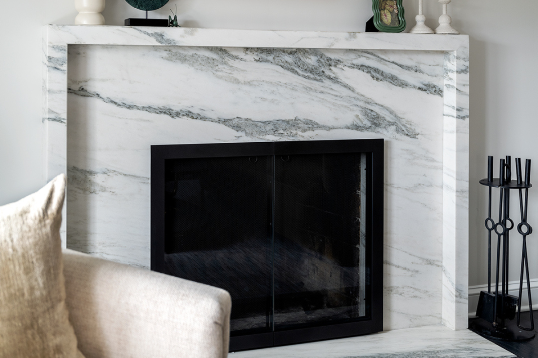White marble fireplace surround in elegant Houston Texas living room