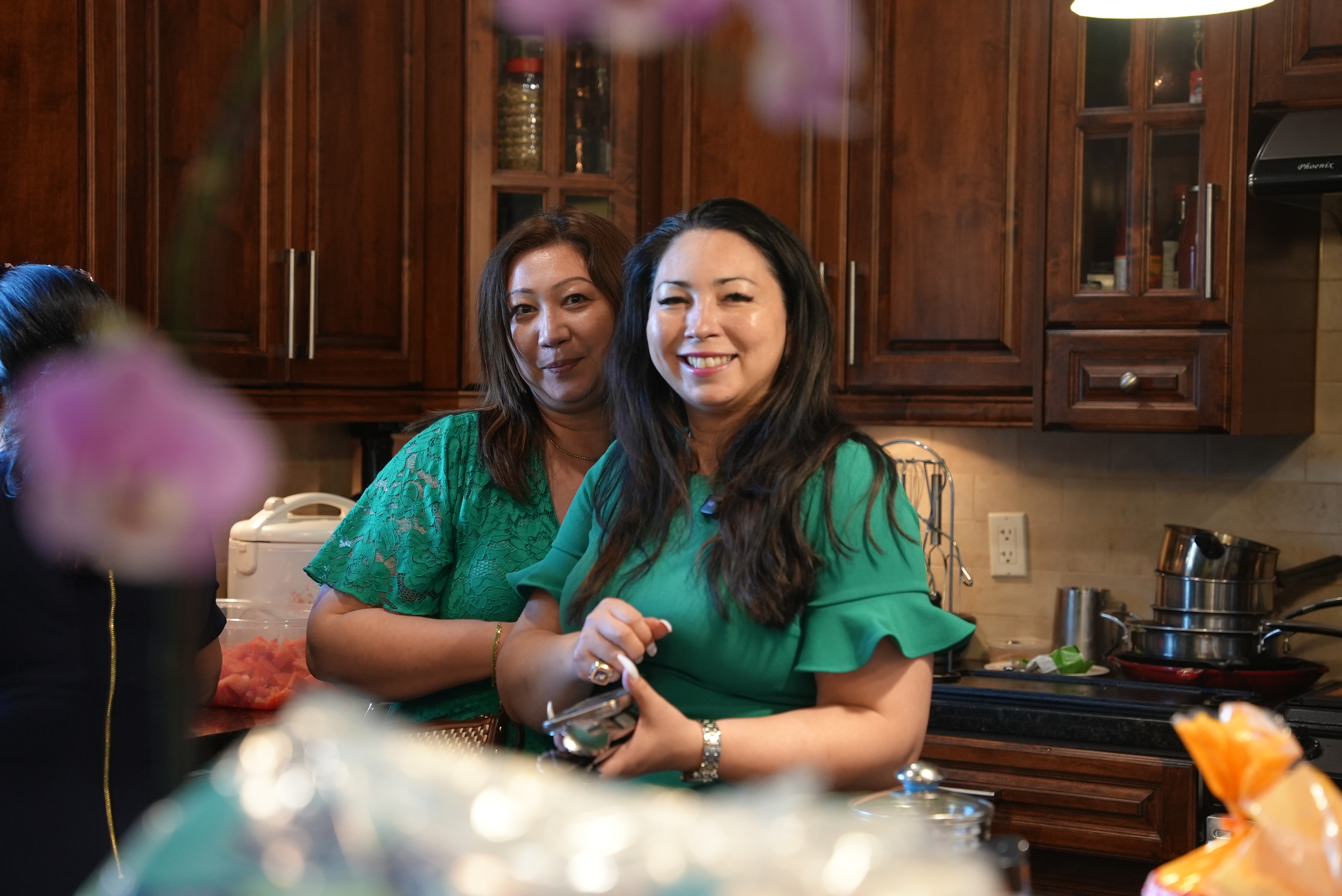Naomi sharing a warm moment with a client in a kitchen setting