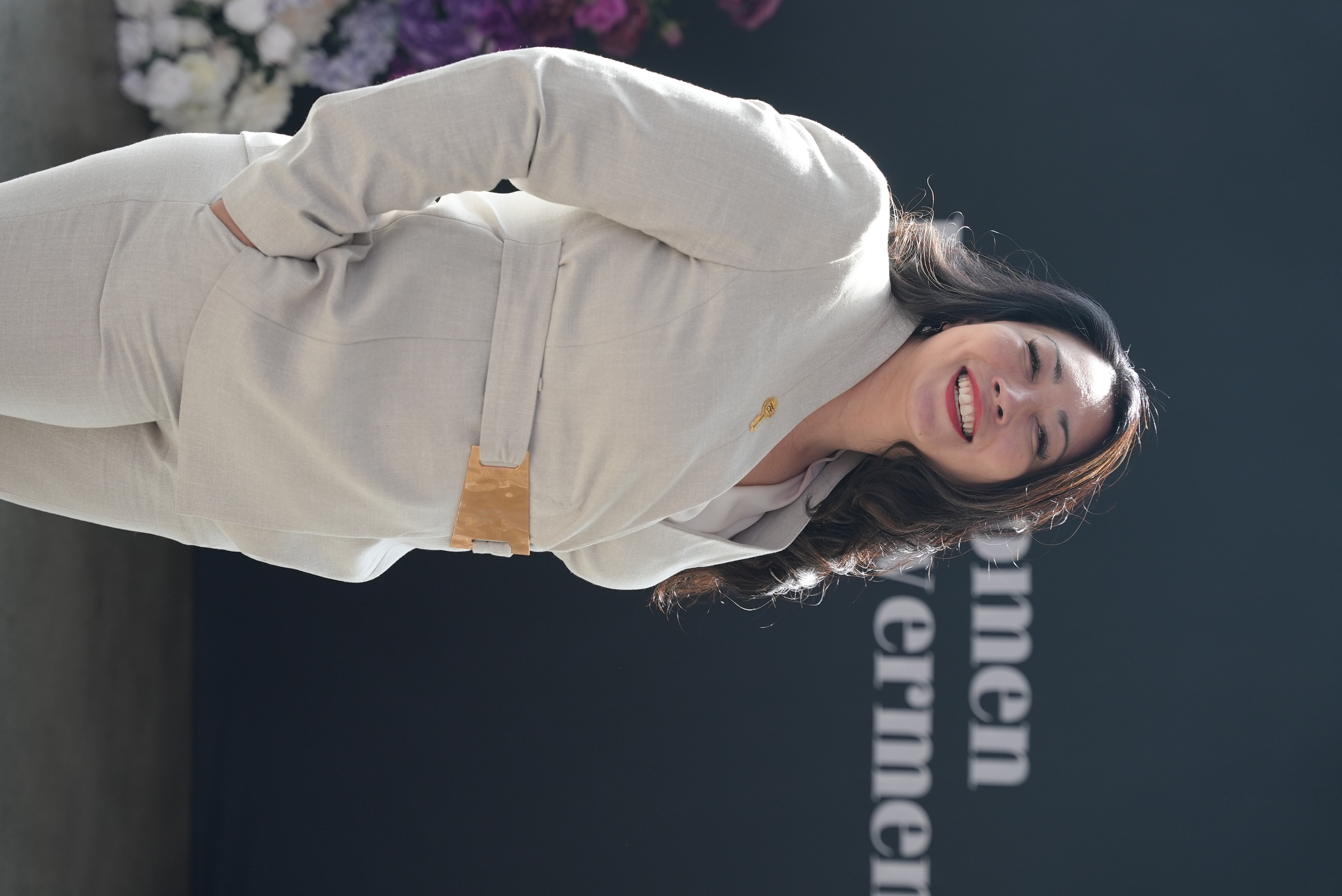 Naomi Pedersen laughing after speaking at a women's empowerment summit