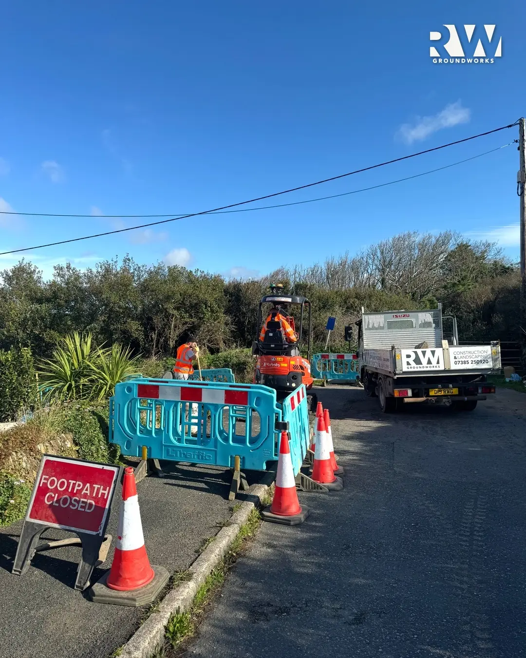 Footpath closed sign, barriers and cones on a Newquay street during the dropped kerb works