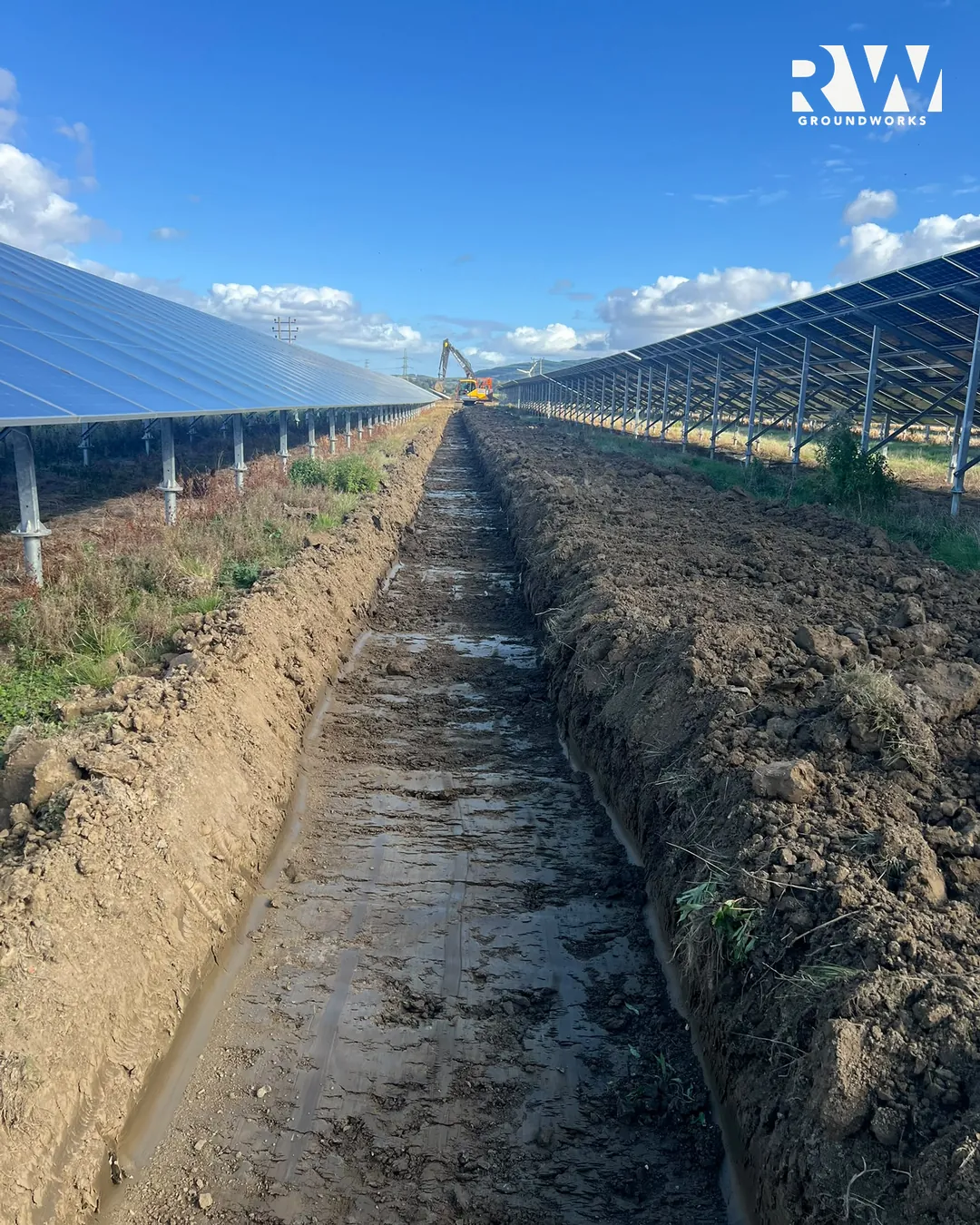 Drainage trench cut between two rows of solar panels at the X2 solar farms