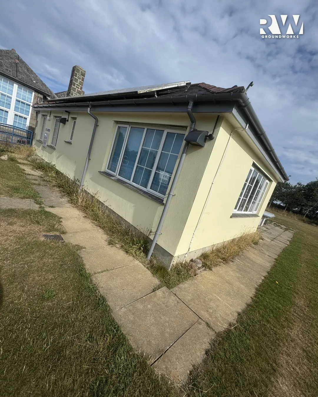 Gwinear school before: cracked narrow path along the classroom