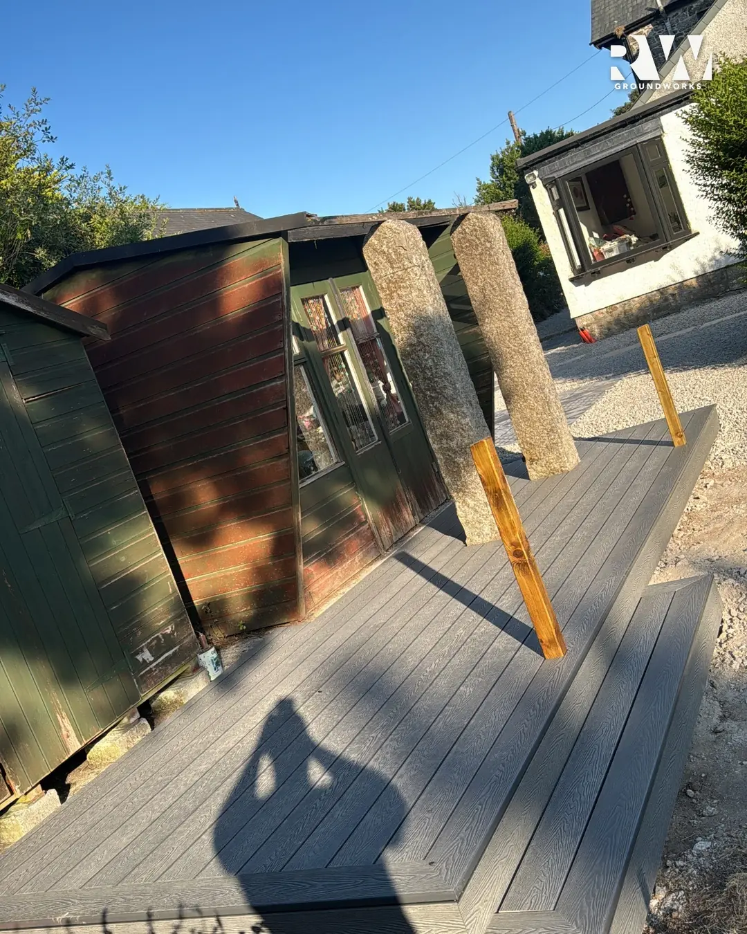 Composite decking with steps beside the garden room in Wendron