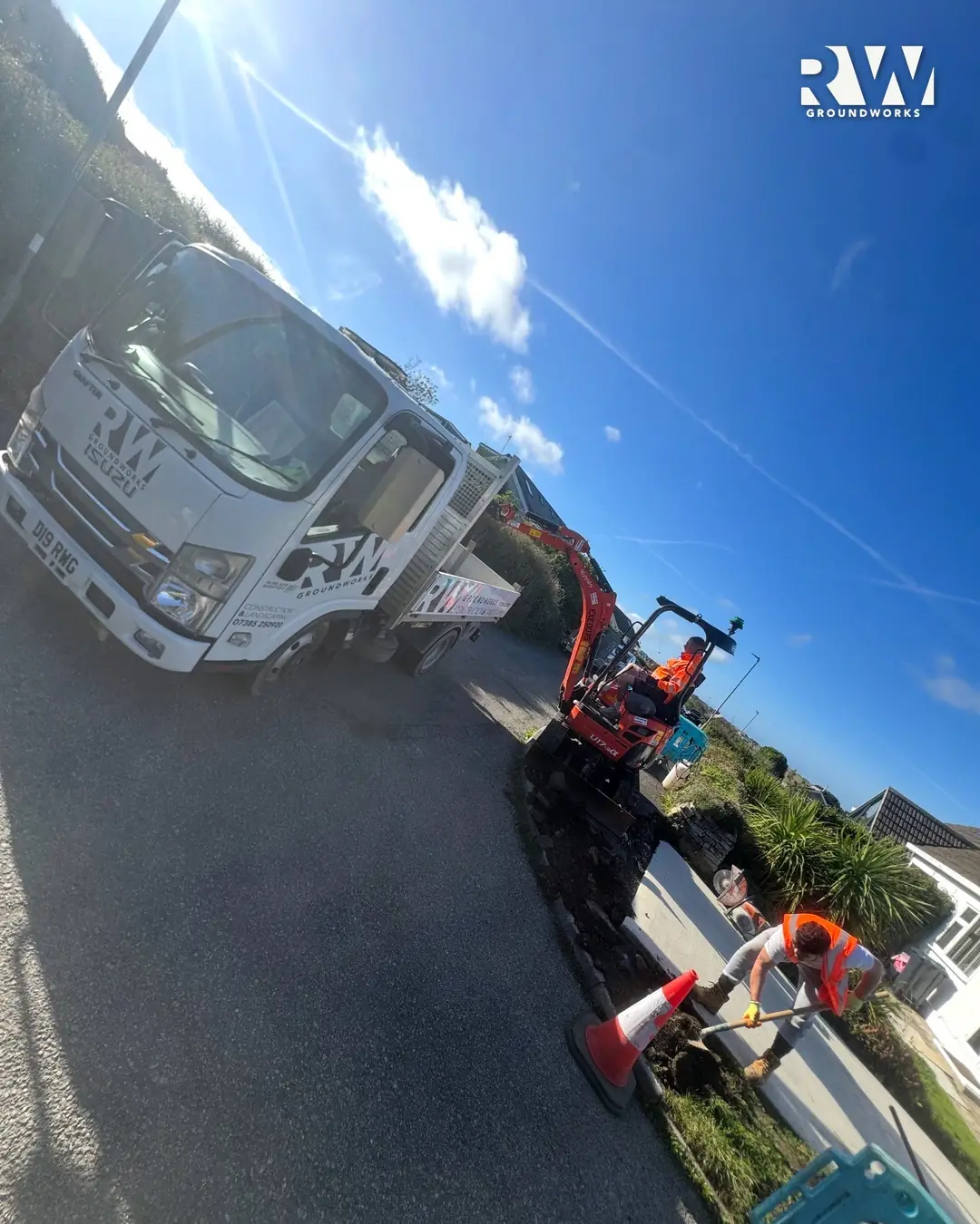 Mini excavator digging out the kerb line in Newquay