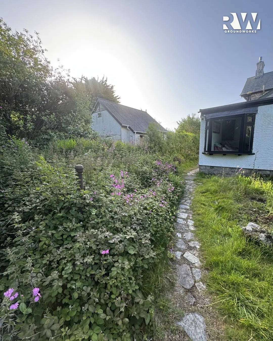 Wendron before: overgrown path choked with weeds leading to the house