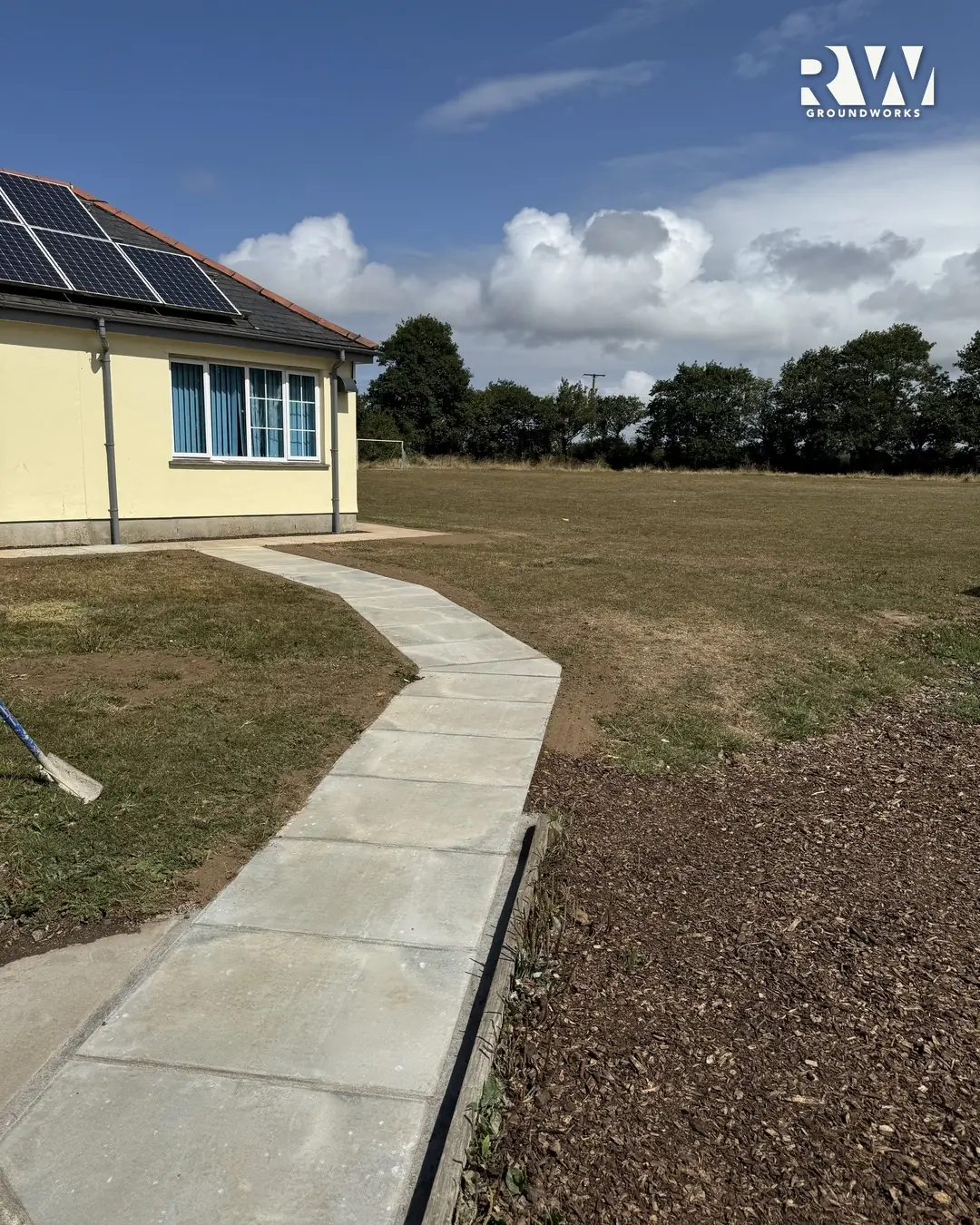 New concrete path across the playing field at Gwinear Community Primary School