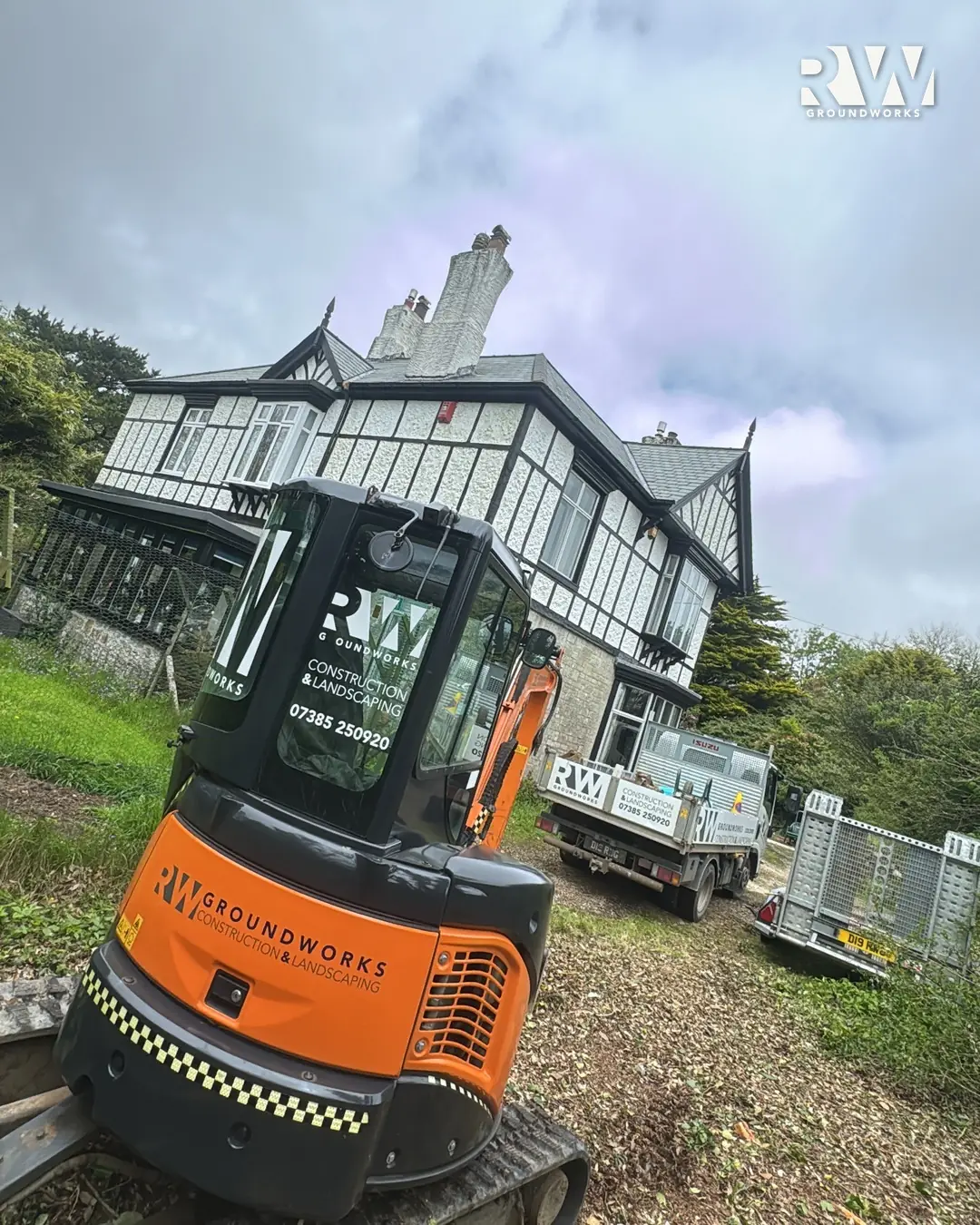 RW Groundworks branded mini digger on site in Wendron