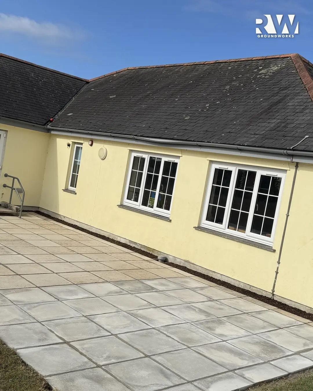 New paved terrace running the length of the classrooms at Gwinear Community Primary School