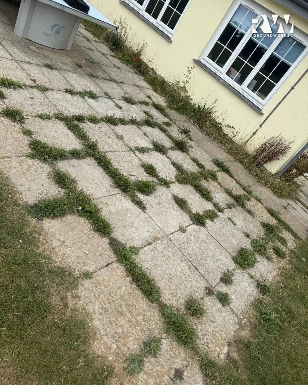Gwinear school before: old slabs with grass growing through the joints