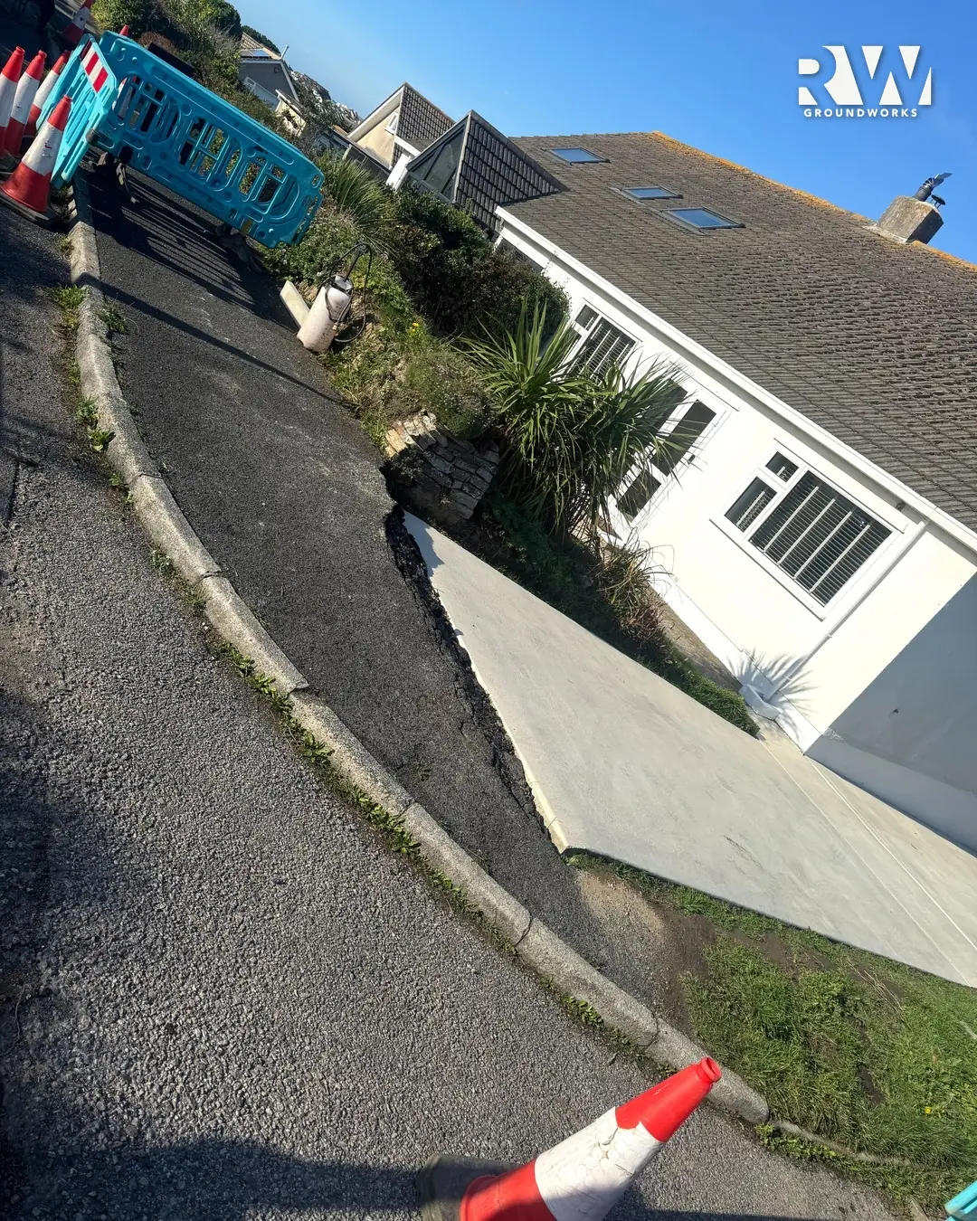 The old kerb line and worn footway outside a bungalow in Newquay before the dropped kerb