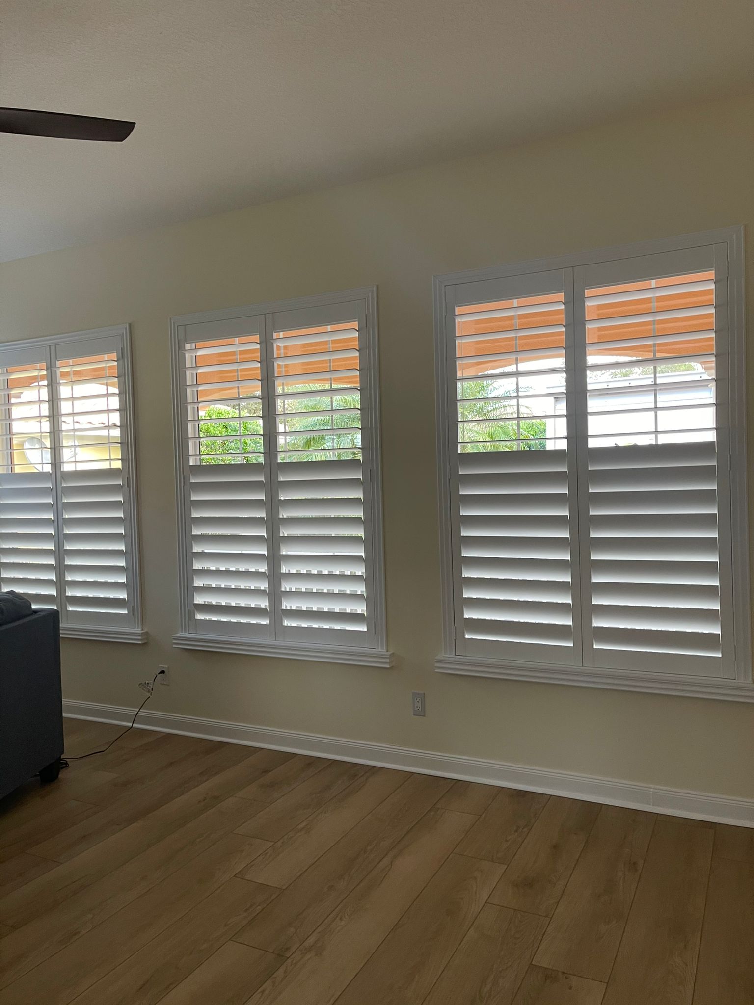 White plantation shutters on three windows
