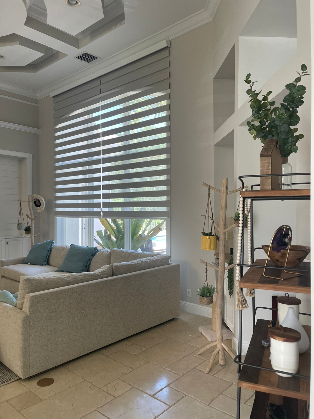 Zebra shades in a living room with built-in shelving