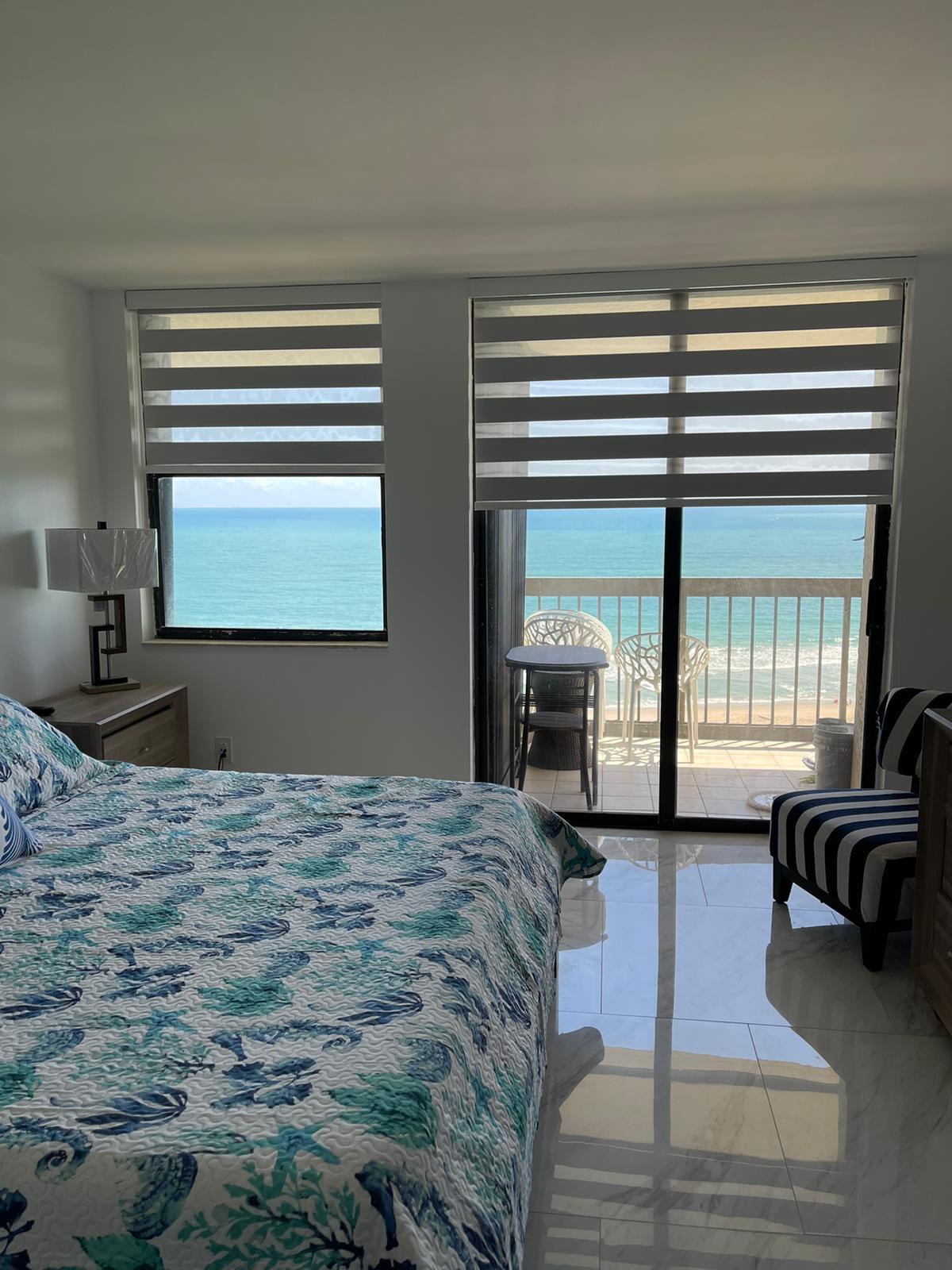 Zebra shades in a bedroom overlooking the ocean