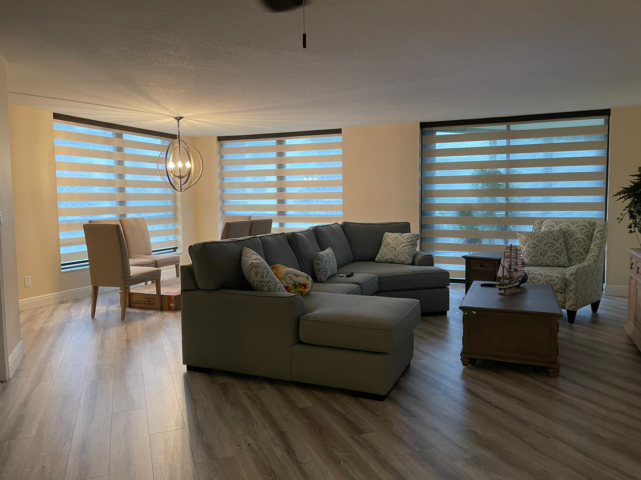 Zebra shades on three windows in a large living room