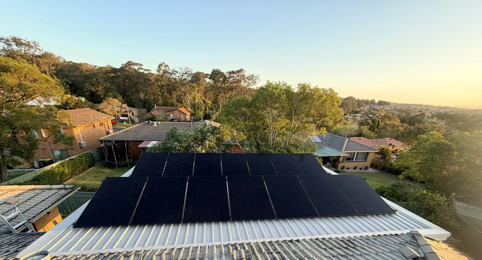 Black solar panels installed by Dunamis Power on a metal roof
