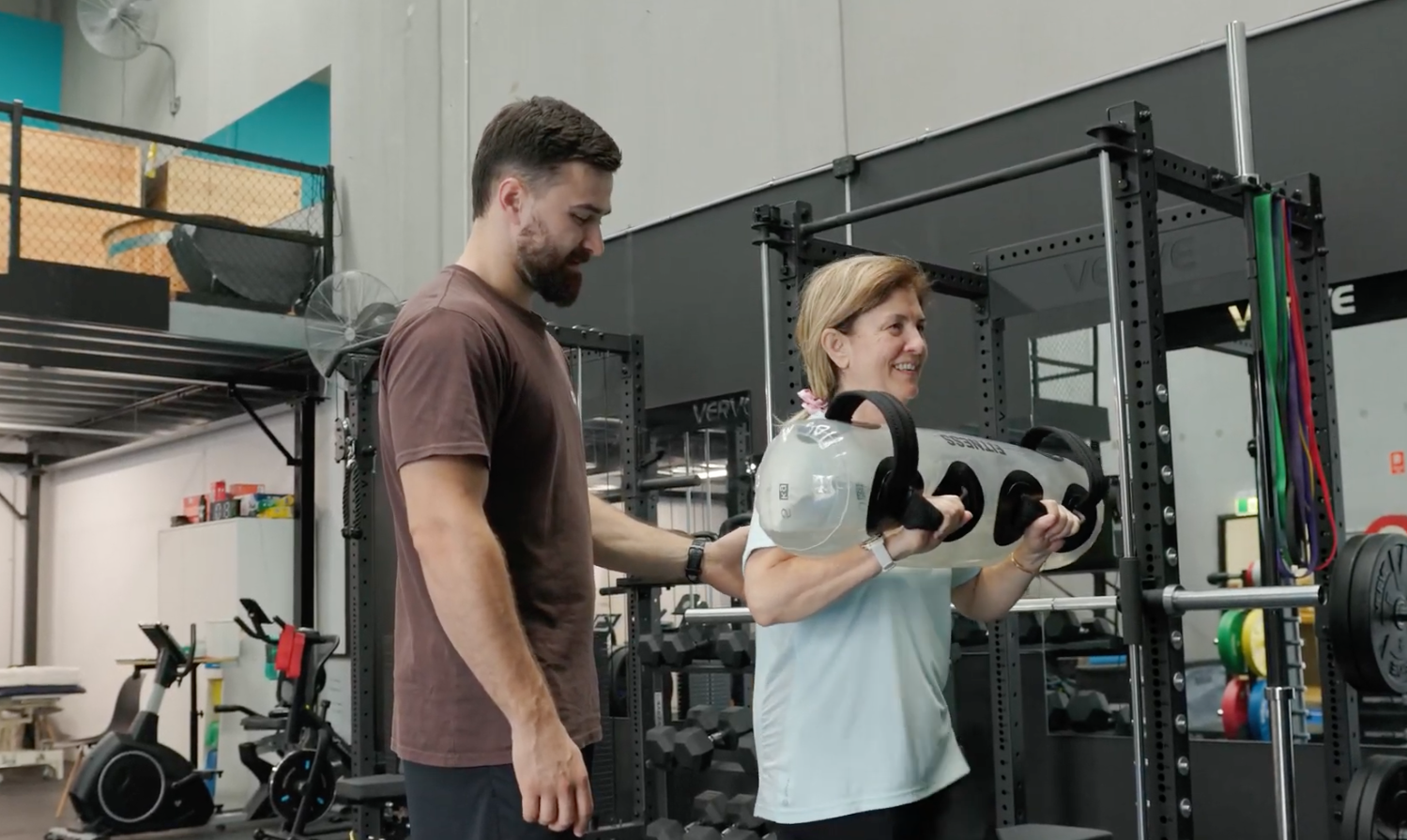 Chris supporting a client during strength training at Regen Health