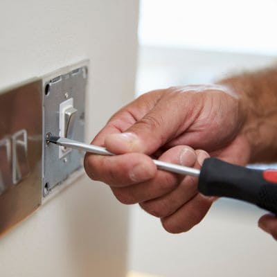 Wall light switch installation with screwdriver