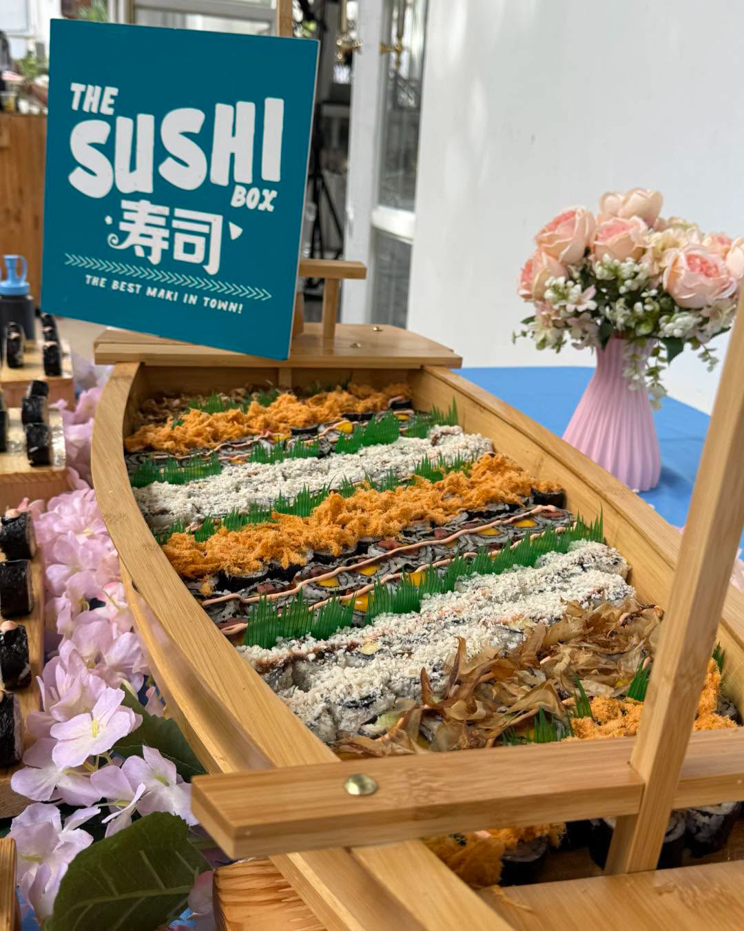 Close-up of the sushi boat's rows of toppings and rolls
