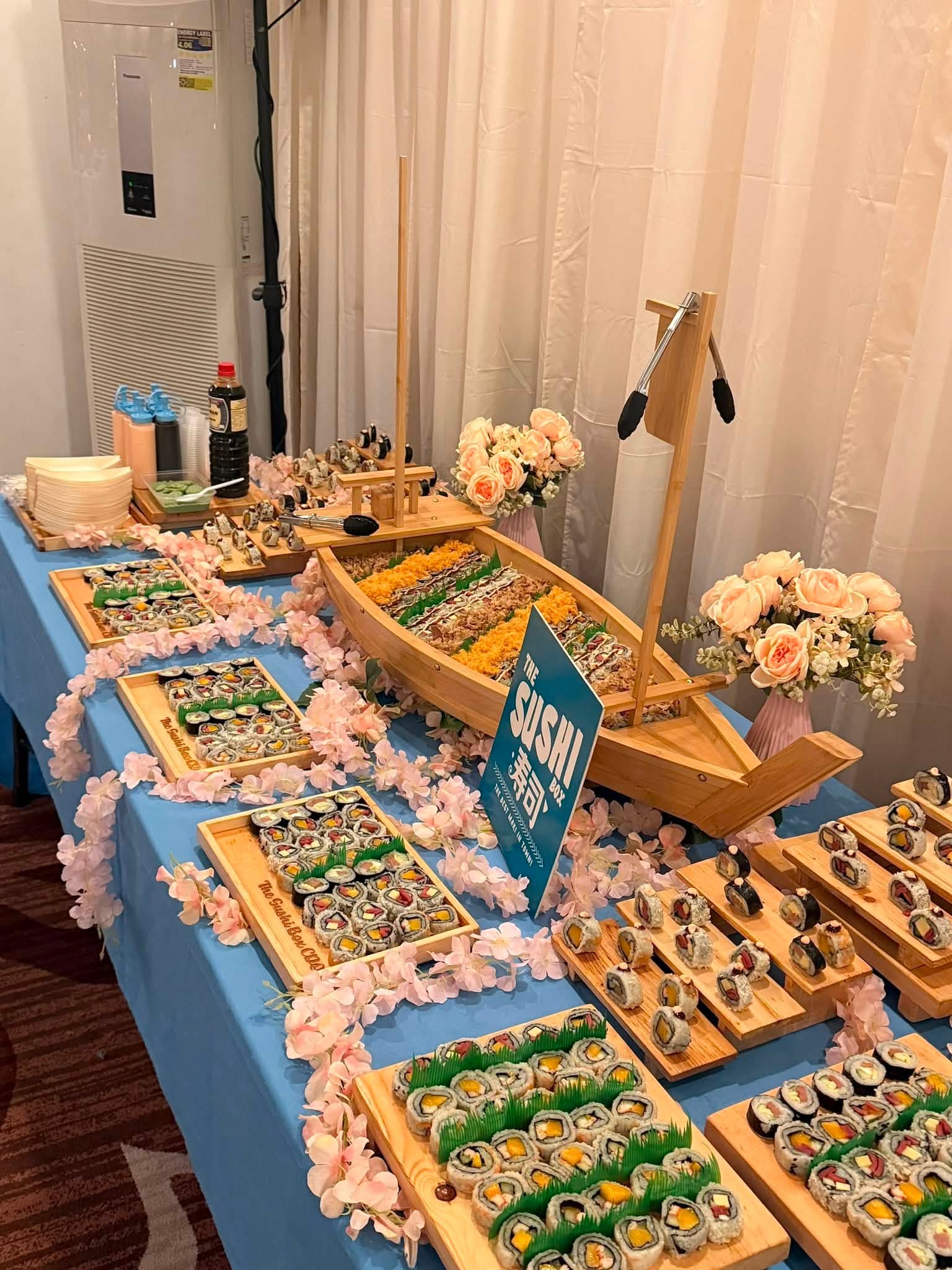 Sushi boat catering table setup at an event