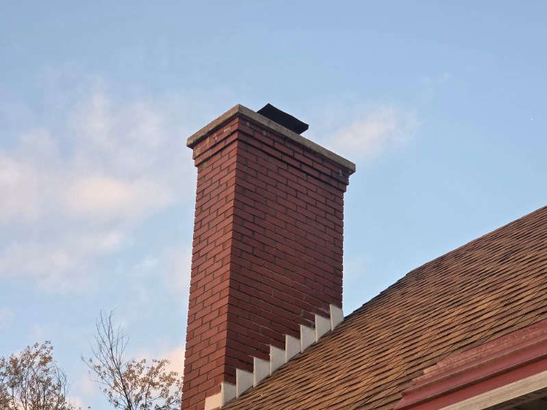 Chimney professional working safely from a roof