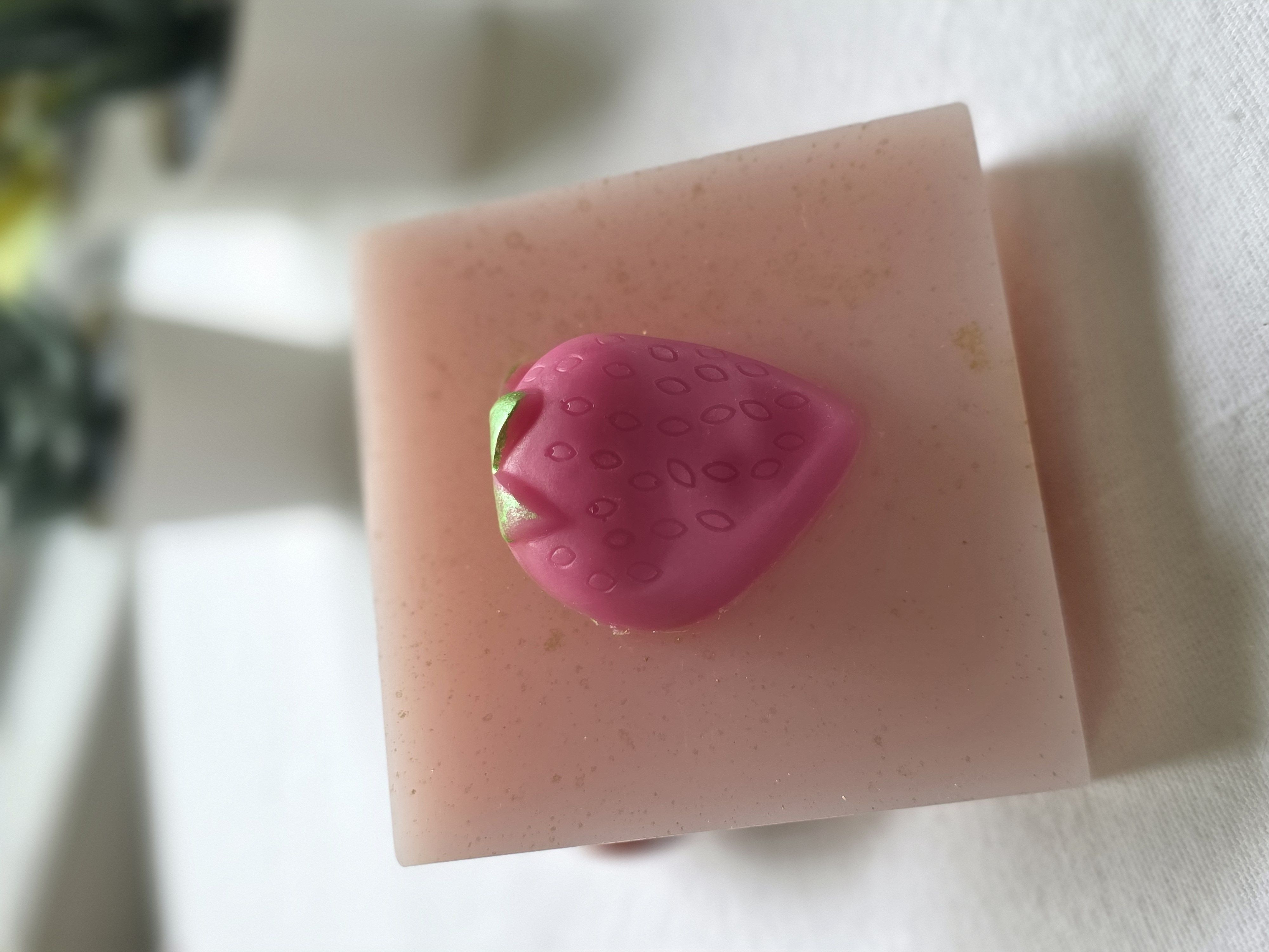 Strawberry Shortcake handmade soap, a square pink bar with gold flecks and a pink strawberry on top