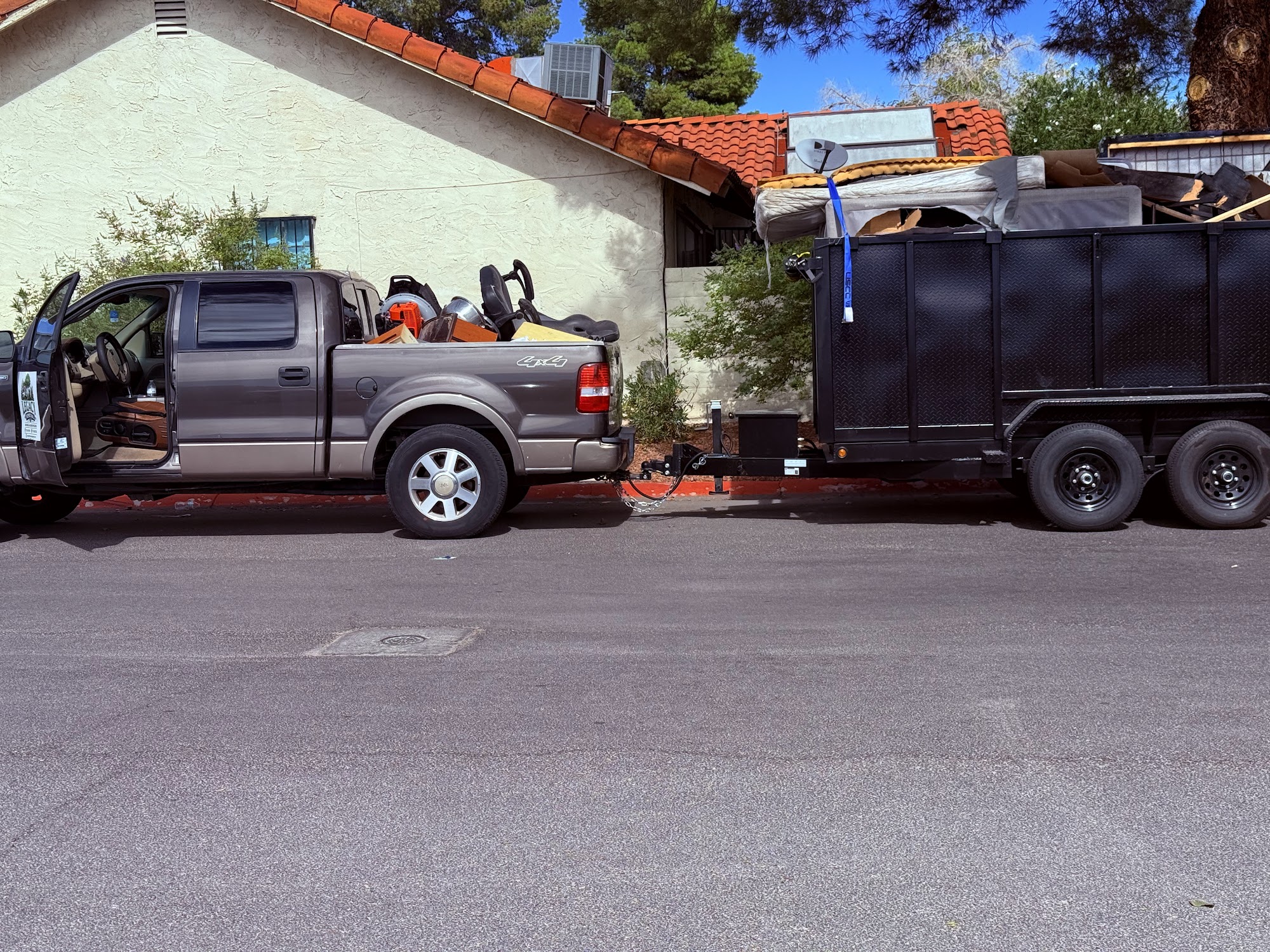 Legacy Removal Company pickup and trailer loaded for a haul